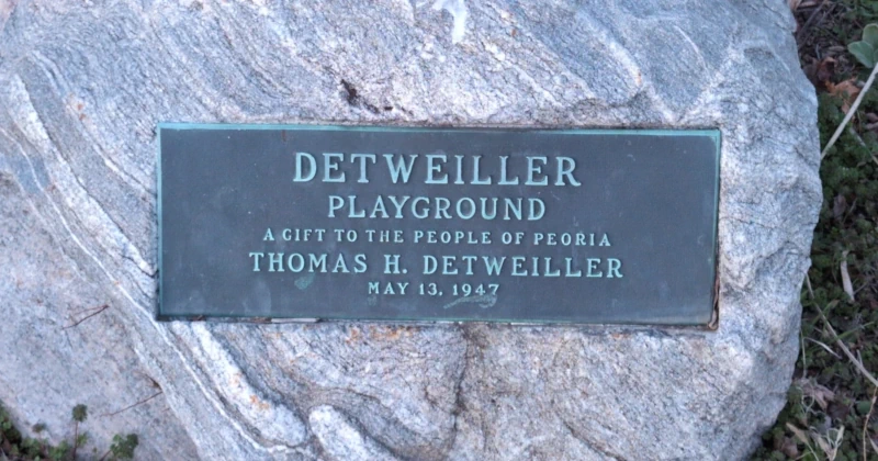 A picture of a monument that reads: Detweiller Playground, A gift to the people of Peoria. Thomas H. Detweiller. May 13, 1947